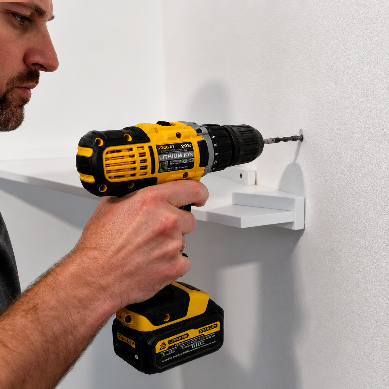 Customer drilling a shelf bracket into a wall